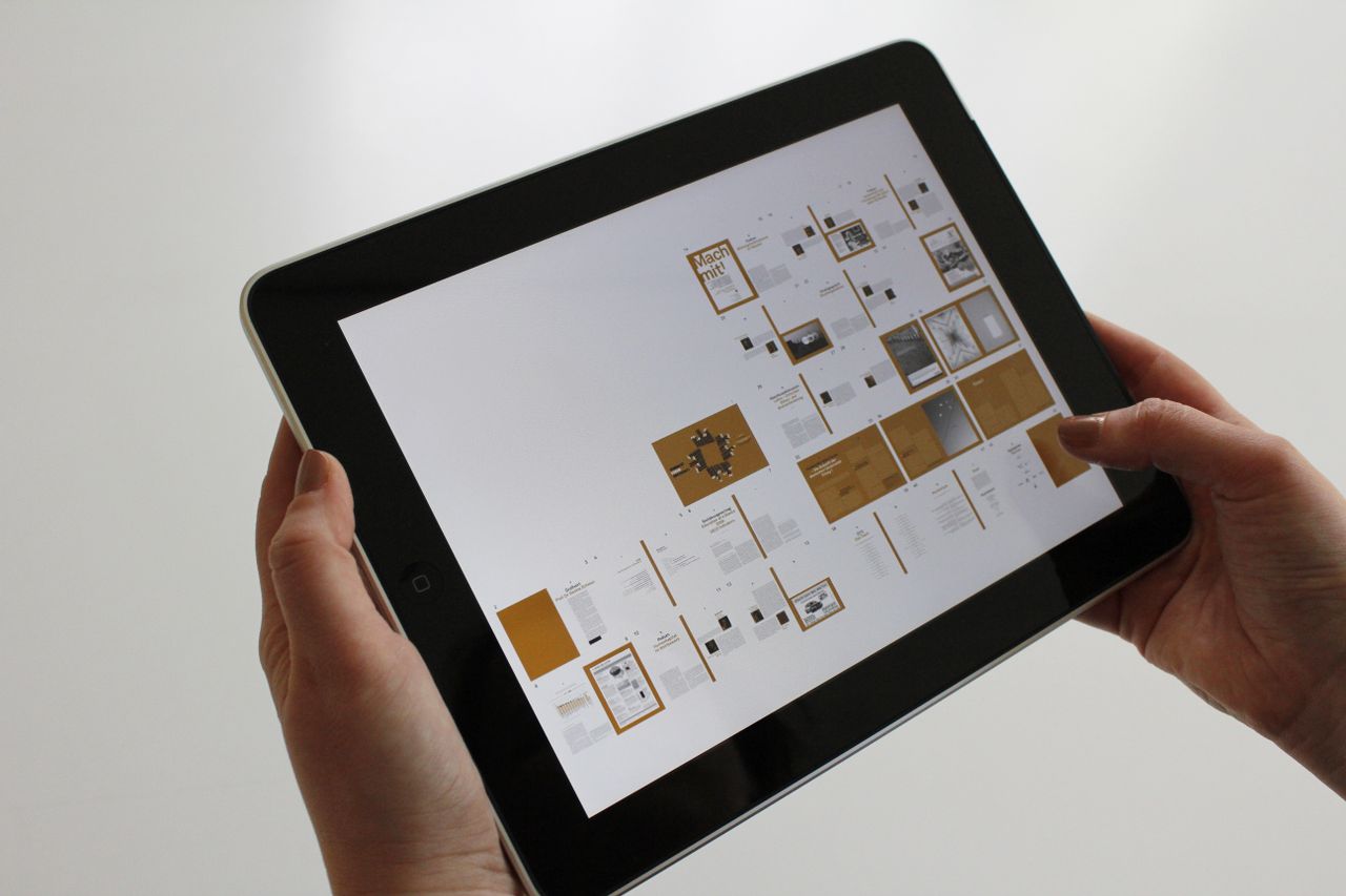 who-we-are Close-up of hands using a tablet, displaying a digital interface.