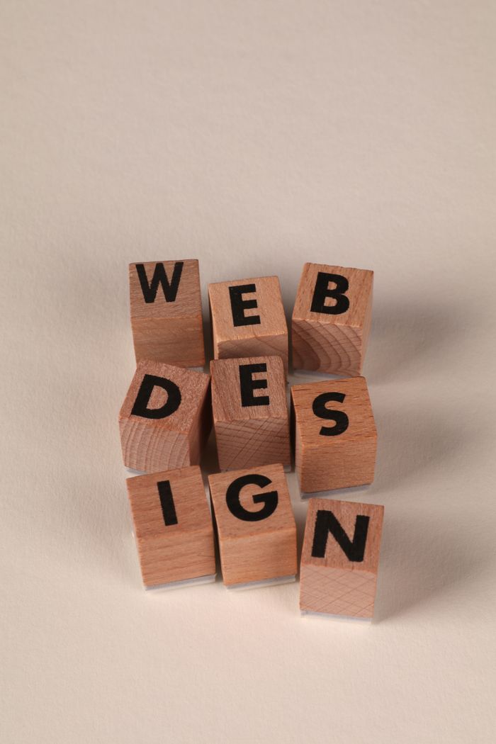 why-choose-us Wooden blocks arranged to spell Web Design. Perfect for creative, digital content themes.