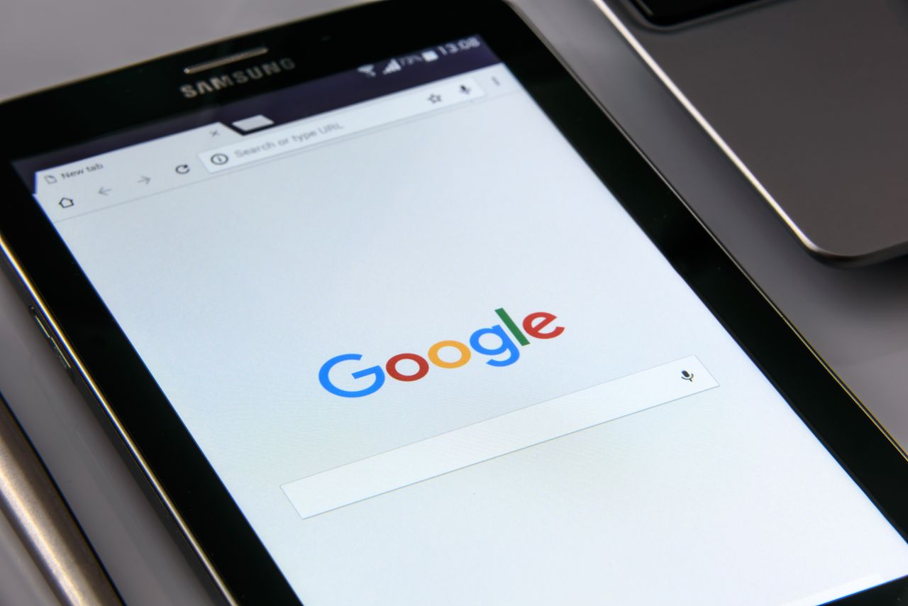 services-03 Close-up of a tablet displaying Googles search screen, emphasizing technology and internet browsing.
